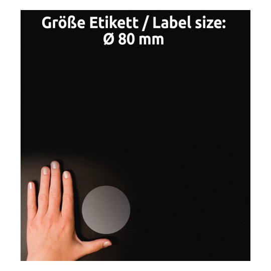 A kép egy kéz helyzetét mutatja egy kör alakú címke közelében, sötét háttérrel, a címke mérete pedig Ø 80 mm, fehér szöveggel jelölve.