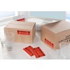 The image shows two cardboard boxes labeled 'Fragile' with glassware nearby. There are glass tumblers on the table and several warning labels indicating fragility.
