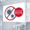 A képen egy olyan jel látható, amely 99,9%-os antimikrobiális tulajdonságot jelöl, vírusokat ábrázoló grafikákkal, amelyeken piros kör és átlós vonal van áthúzva.