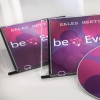A képen két CD-tok látható 'Sales Meeting' címmel és egy lemez színes dizájnnal. A dizájn rózsaszín és lila árnyalatú köröket tartalmaz, valamint a 'beEven' szöveget.