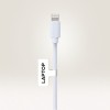 A képen egy fehér töltőkábel látható Lightning csatlakozóval, amelyre egy 'LAPTOP' feliratú címke van rögzítve.