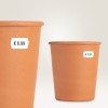 The image features two terracotta flower pots with price tags of €6.99 and €3.99.