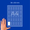 Kéz egy A4-es lap mellett, amelyen egy 30 × 50 mm feliratú diagram látható kis téglalap alakú cellákkal?