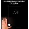 A kép egy kezet ábrázol egy A4-es méretű lap mellett, amelyen egy 30 mm-es kör alakú címke méretjelzés látható sötét háttér előtt.