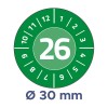 A kép egy zöld háttérrel ellátott kör alakú mérőt ábrázol. A 26-os szám kiemelten helyezkedik el a középen, körülötte 1-től 12-ig terjedő számok láthatók körkörös mintázatban. A kör alatt egy 30 mm-es átmérőt jelez.