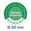 A kép egy kör alakú ellenőrzési dátum emlékeztetőt mutat, amelynek közepén a 'Nächster Prüftermin' szöveg található. A szélén dátumot jelző jelek és számok láthatók, továbbá egy 20 mm-es átmérőre vonatkozó utalást is tartalmaz.